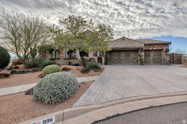 996 Homestead Circle St. George, UT 84770 - Photo 1 of 1 View of front of house with a garage, driveway, and stone siding