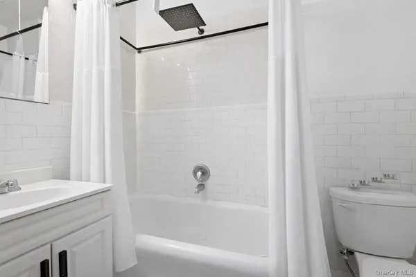a bathroom with a sink vanity and toilet