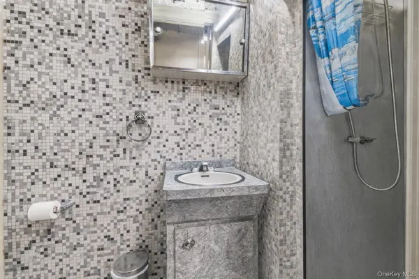 a bedroom with a bed chandelier and a window