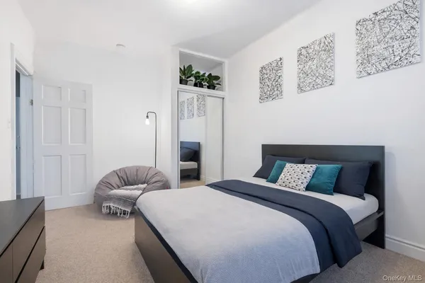 a spacious bedroom with a bed and a window