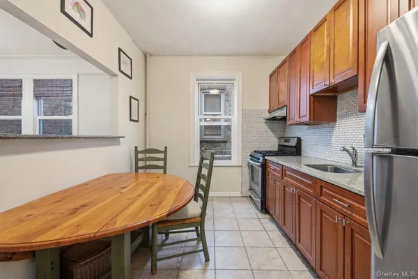 a kitchen with stainless steel appliances granite countertop a kitchen island hardwood floor sink stove and granite counter top