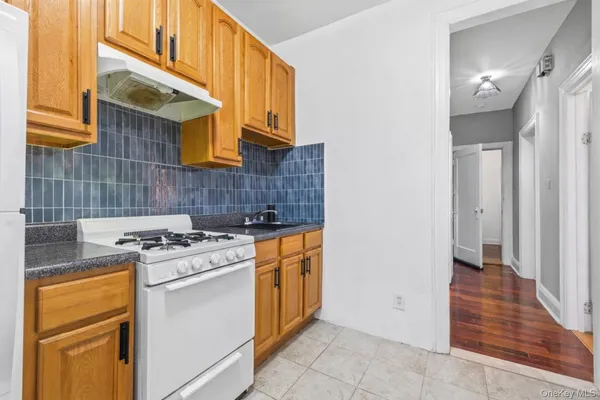 a kitchen with a stove top oven and cabinets
