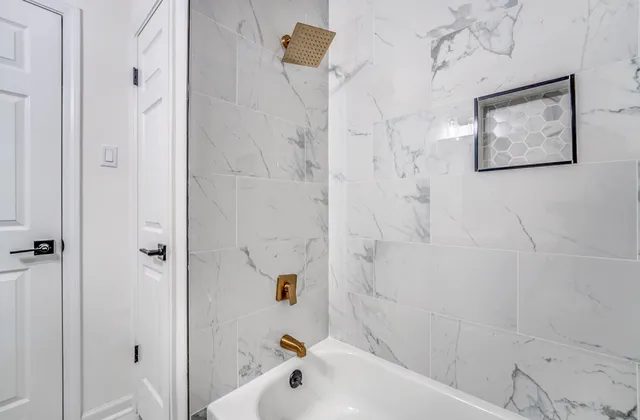 a bathroom with a bathtub and shower