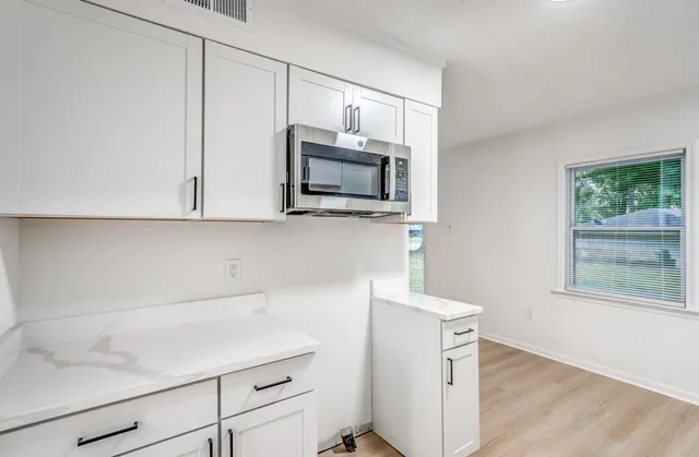 a kitchen with a microwave and a sink