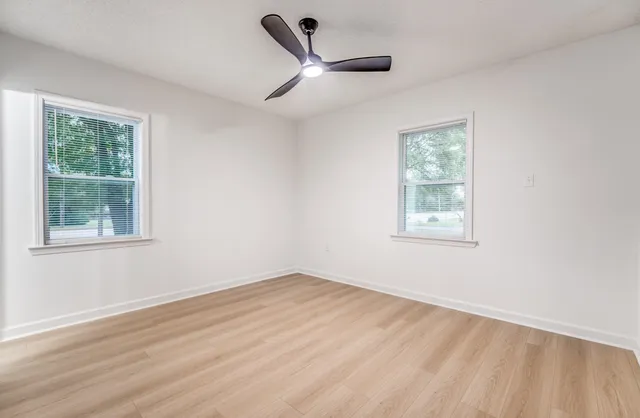 a view of a room with a window and a ceiling fan