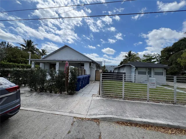 a view of a house with a yard and a garage