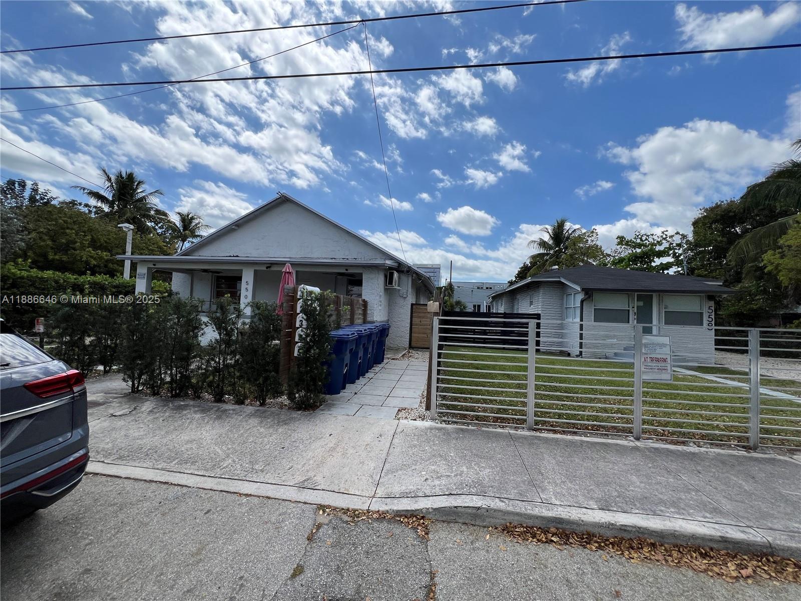 548 Northwest 30th Street, Unit 2 Miami, FL 33127 - Photo 11 of 12 a view of a house with a yard and a garage