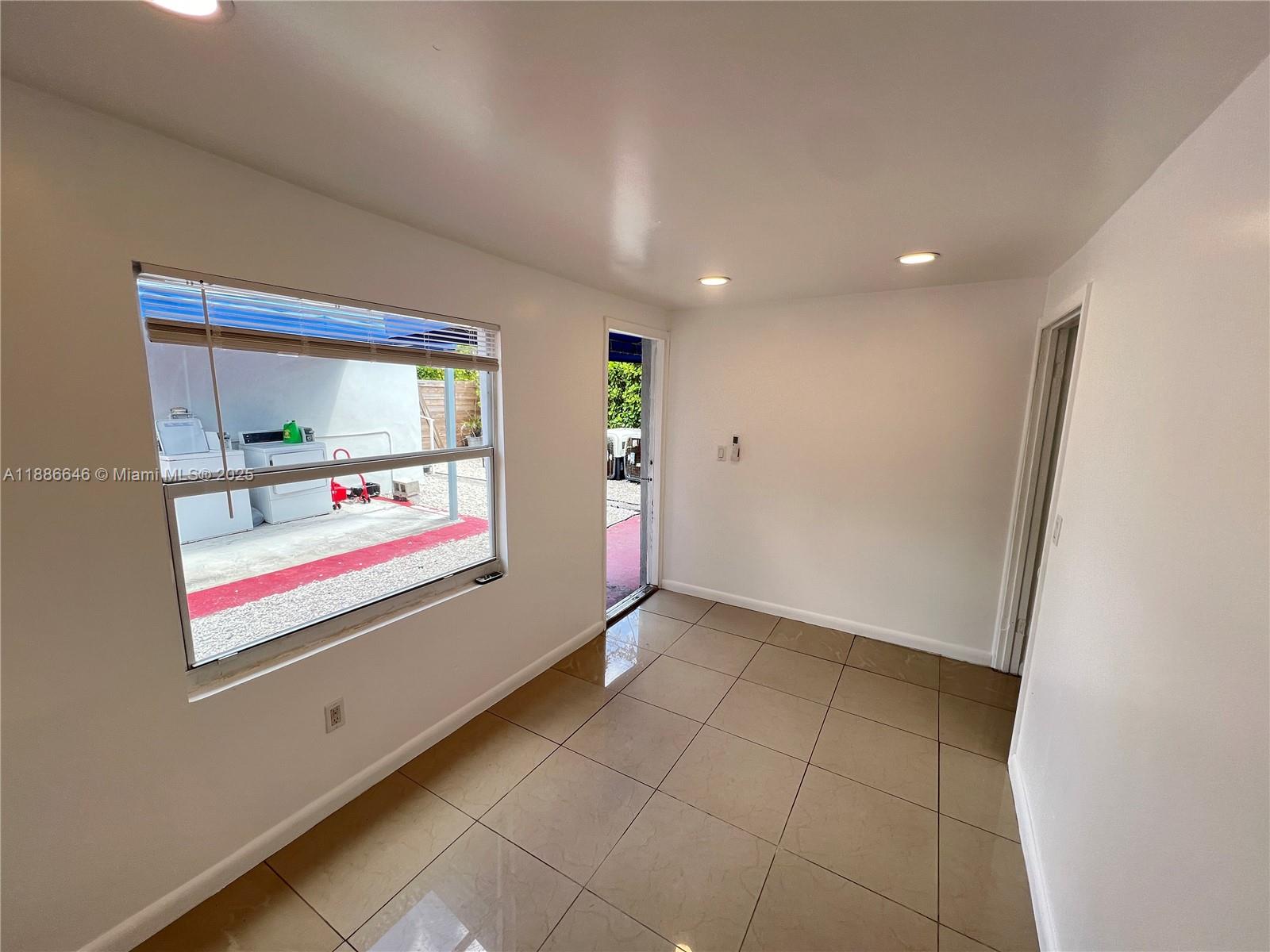 548 Northwest 30th Street, Unit 2 Miami, FL 33127 - Photo 3 of 12 a view of an empty room with a window