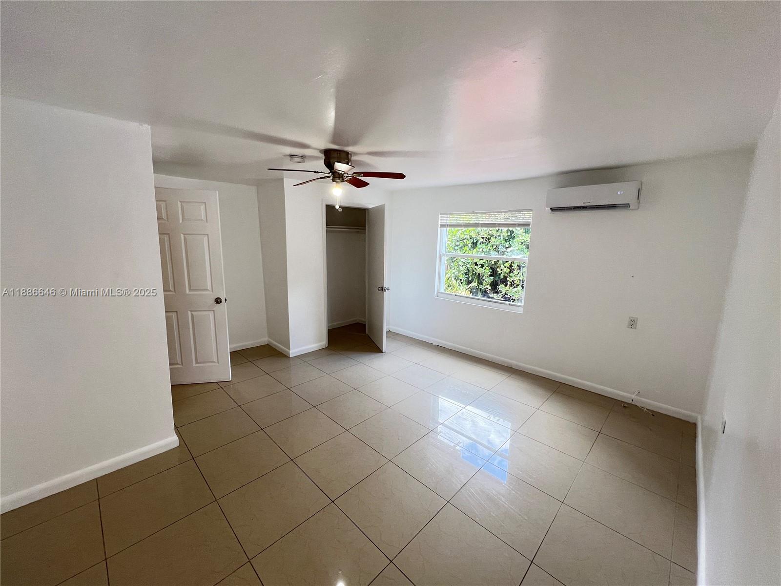 548 Northwest 30th Street, Unit 2 Miami, FL 33127 - Photo 4 of 12 a view of an empty room with a window