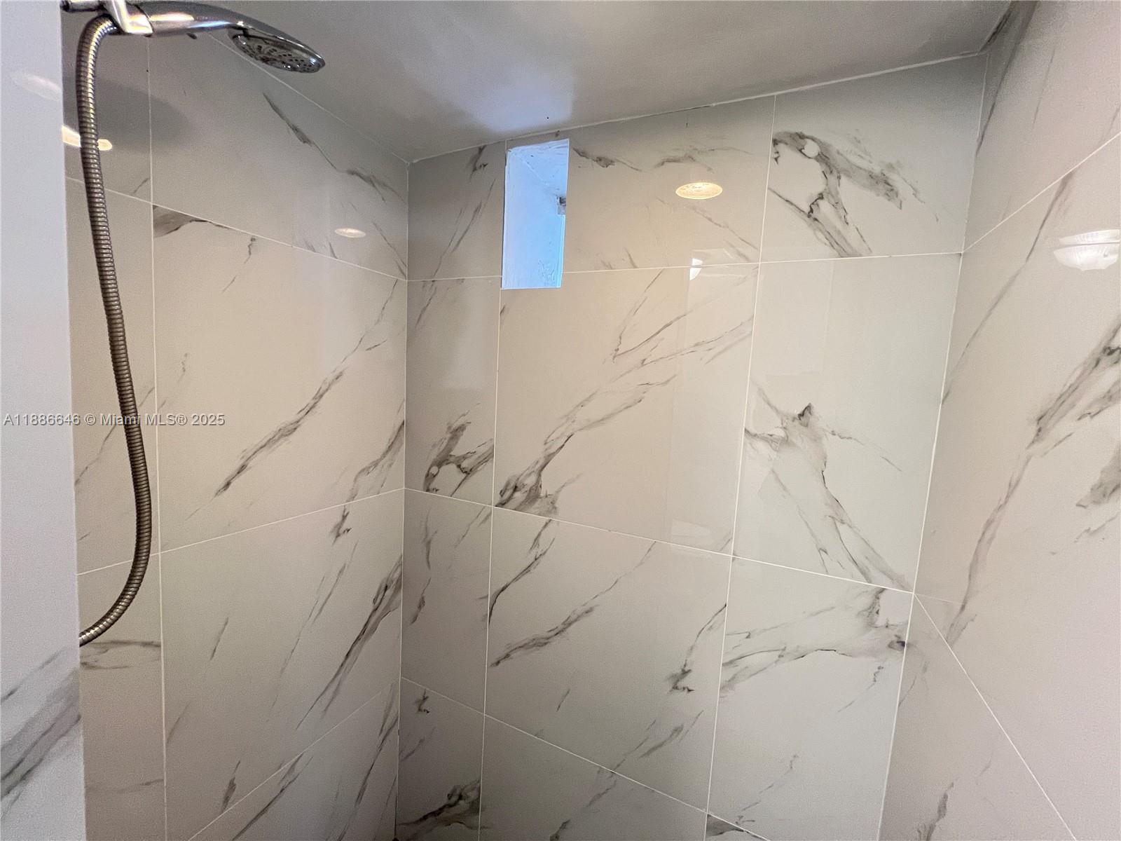 548 Northwest 30th Street, Unit 2 Miami, FL 33127 - Photo 7 of 12 a bathroom with a shower