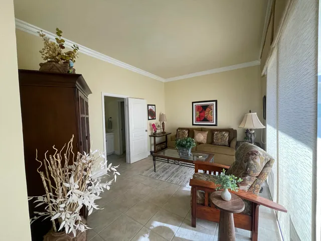 a living room with furniture flowers and a chandelier