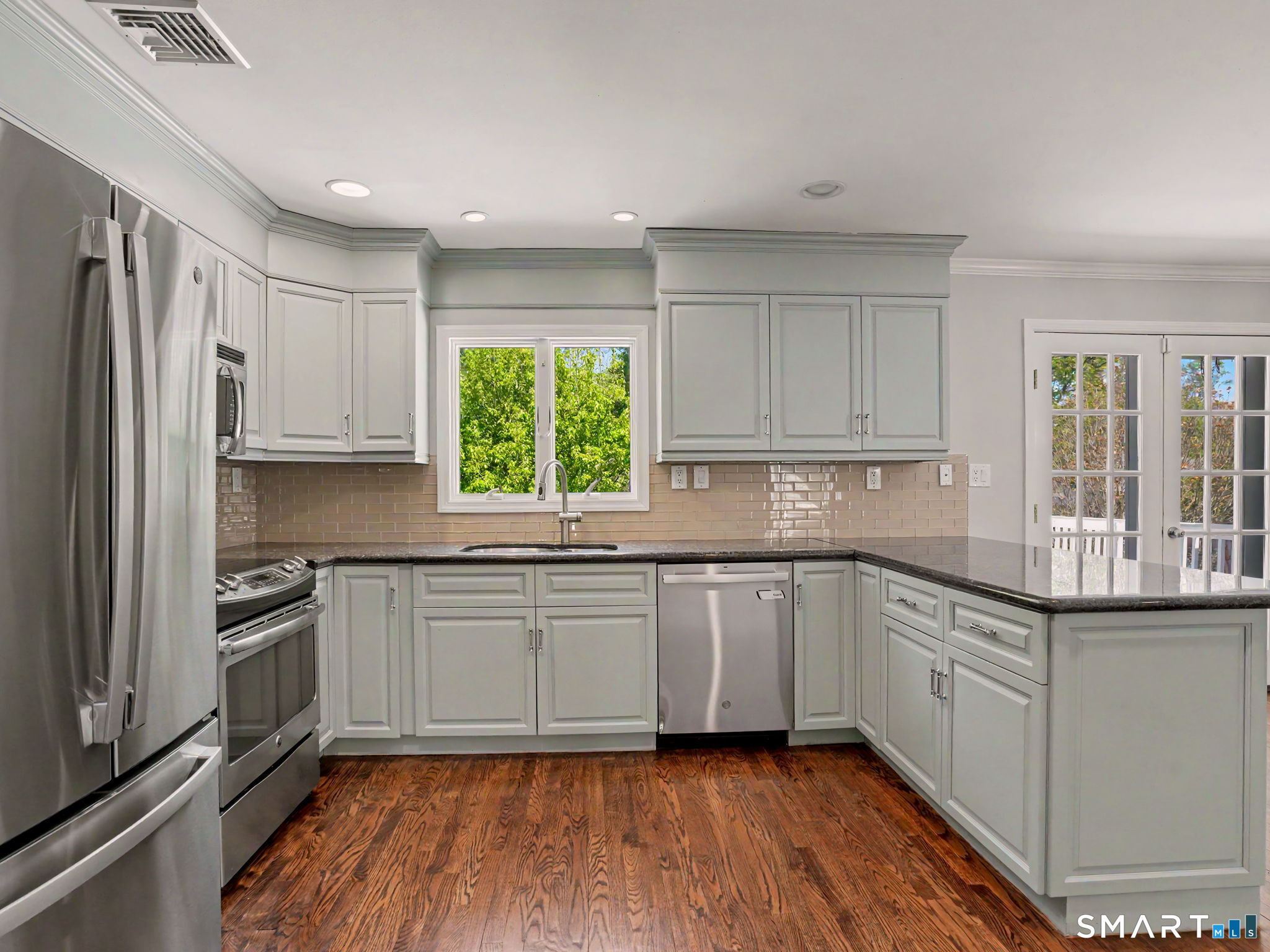 44 Sniffen Road Westport, CT 06880 - Photo 15 of 39 Kitchen with stainless steel appliances and hardwood flooring