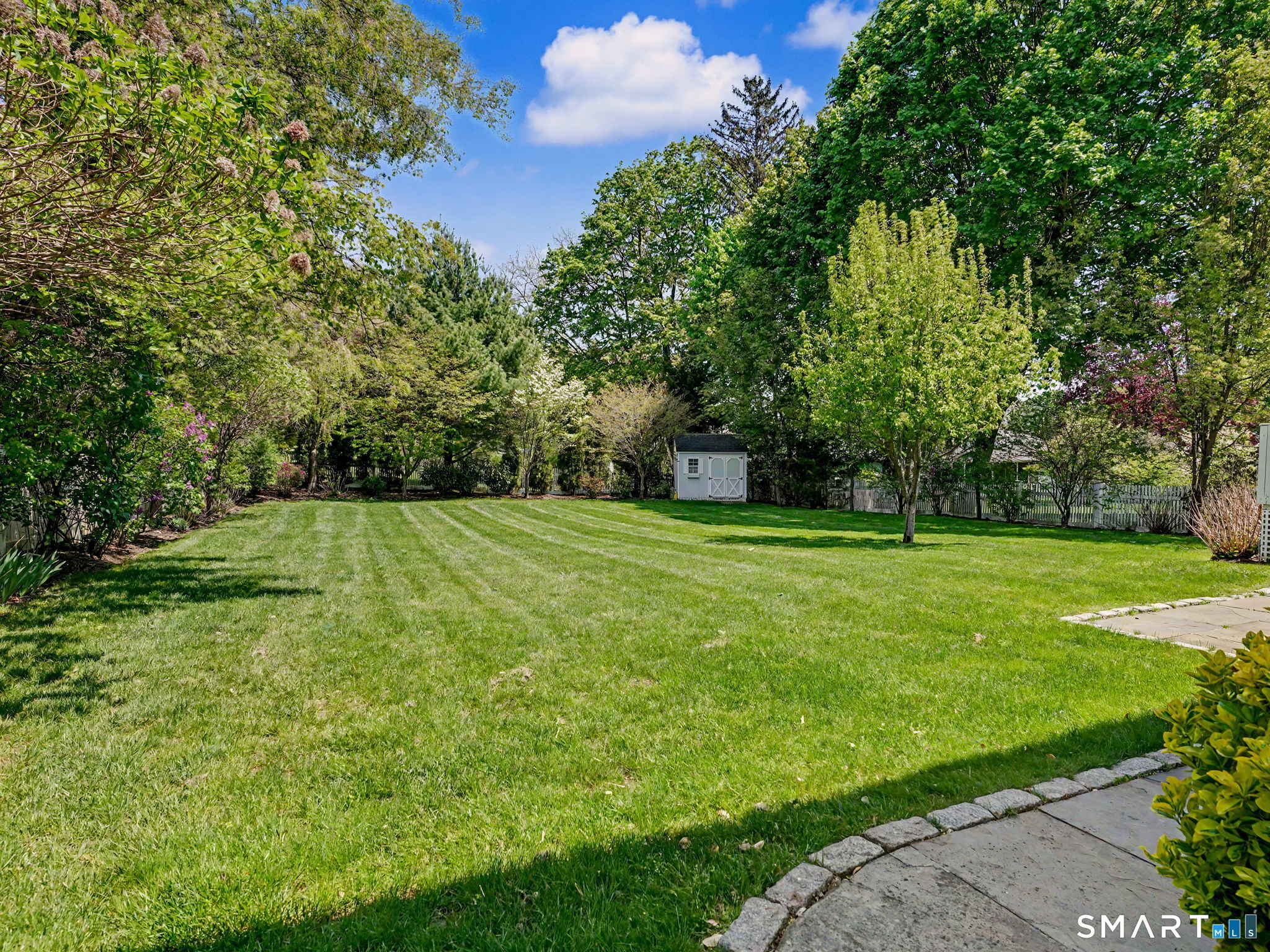 44 Sniffen Road Westport, CT 06880 - Photo 34 of 39 Expansive fully fenced backyard with storage shed in rear. Perimeter features mature specimen trees and perennials.