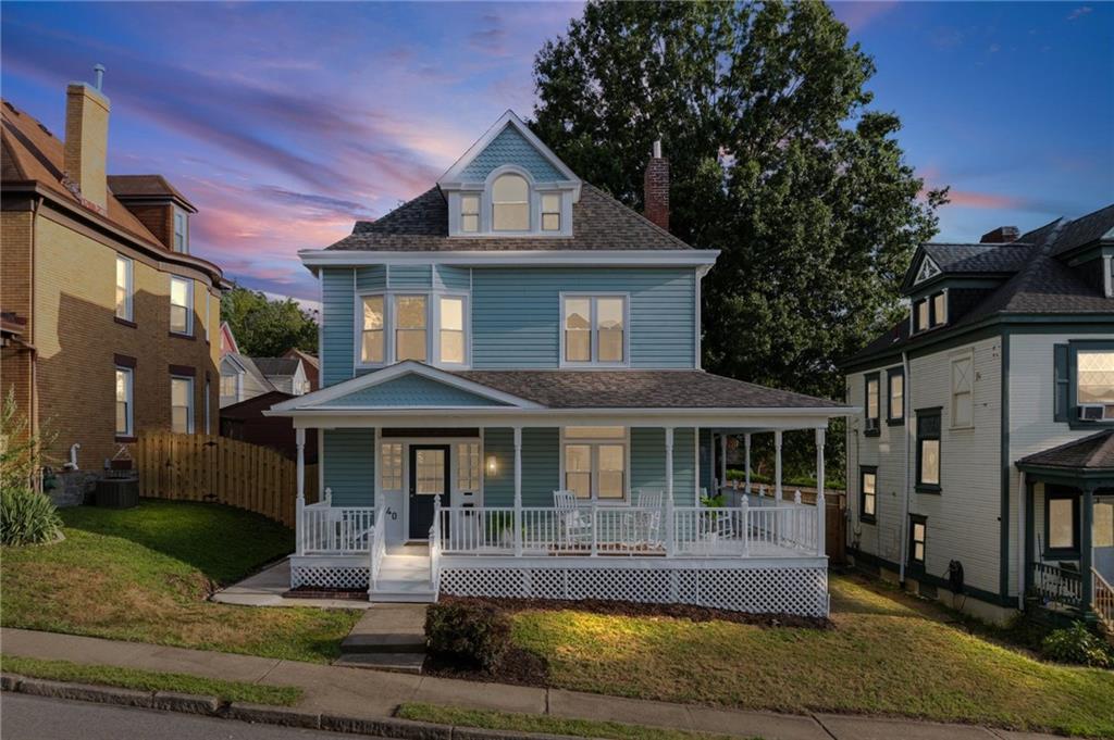 a front view of a house with a yard table and chairs