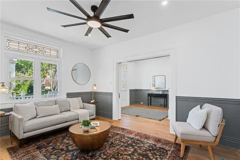 a living room with furniture a rug and a window