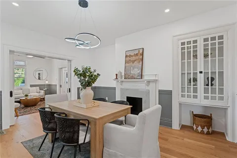 a view of a dining room with furniture wooden floor and a chandelier
