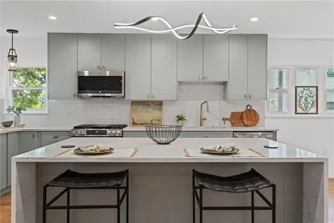 a kitchen with a sink cabinets and appliances