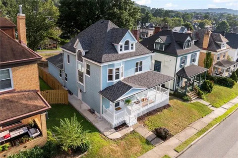an aerial view of a house with a garden