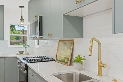 a kitchen with a sink stove and microwave