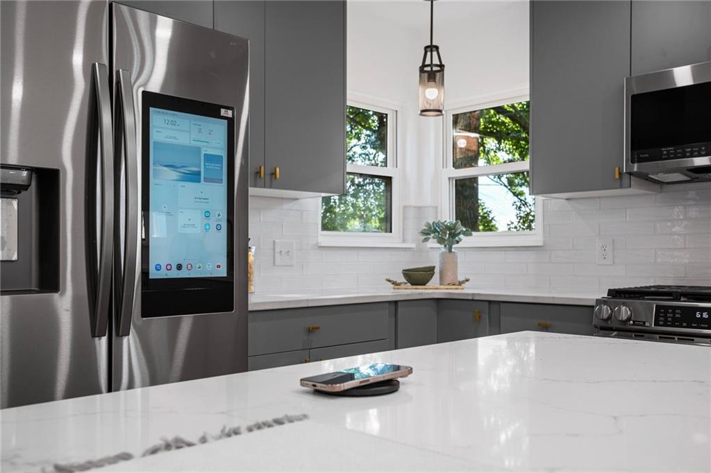 40 Walnut Street Crafton, PA 15205 - Photo 22 of 50 a kitchen with granite countertop a sink and a stove top oven