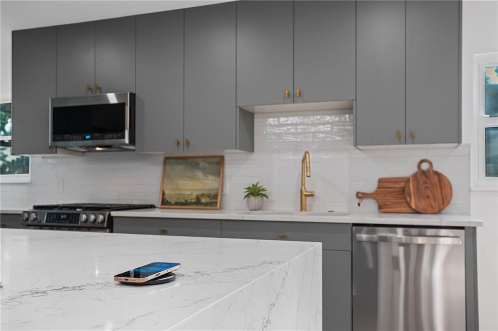 40 Walnut Street Crafton, PA 15205 - Photo 23 of 50 a kitchen with stainless steel appliances granite countertop a sink and a stove