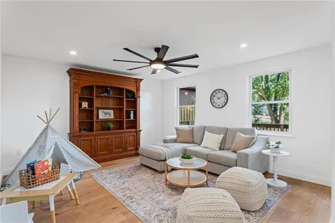 a living room with furniture a rug and a large window