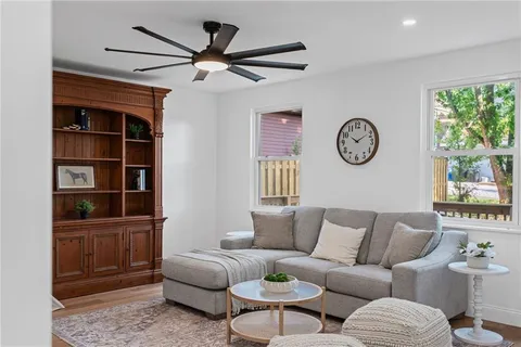 a living room with furniture a window and a clock