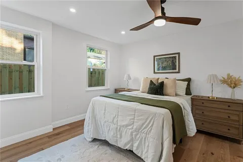 a bedroom with bed and wooden floor