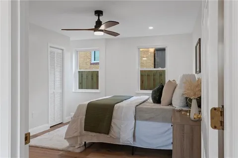 a bedroom with a bed and wooden floor