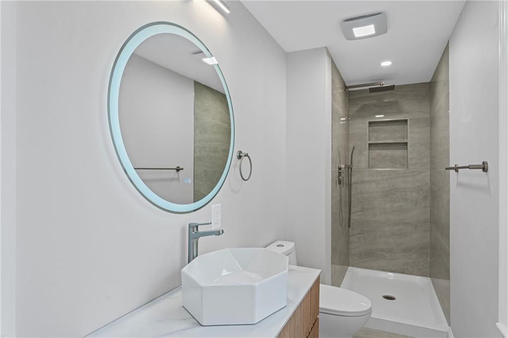 40 Walnut Street Crafton, PA 15205 - Photo 33 of 50 a bathroom with a toilet a sink and a mirror