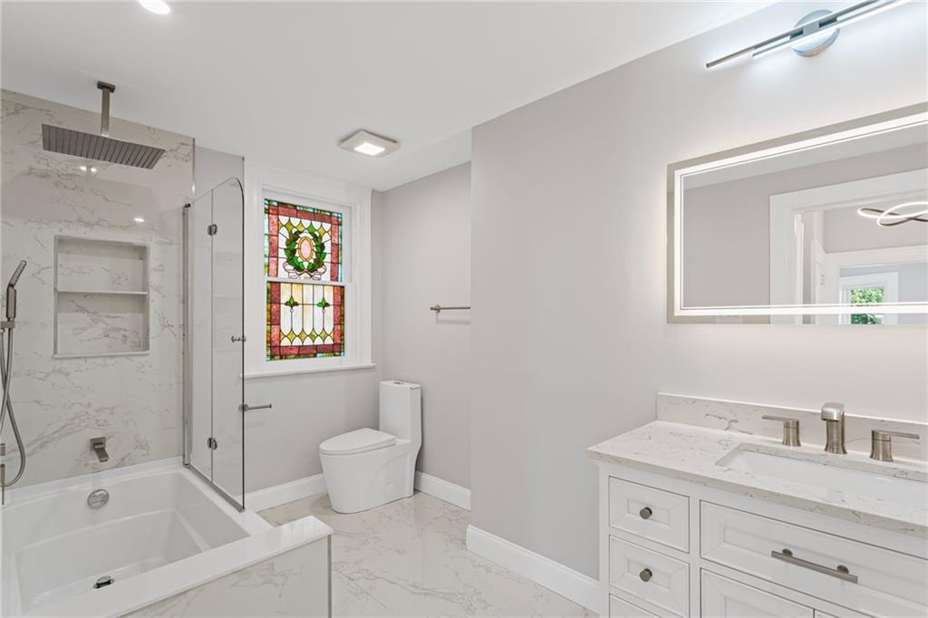 40 Walnut Street Crafton, PA 15205 - Photo 38 of 50 a bathroom with a granite countertop sink a toilet and a mirror