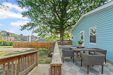 a balcony with table and chairs