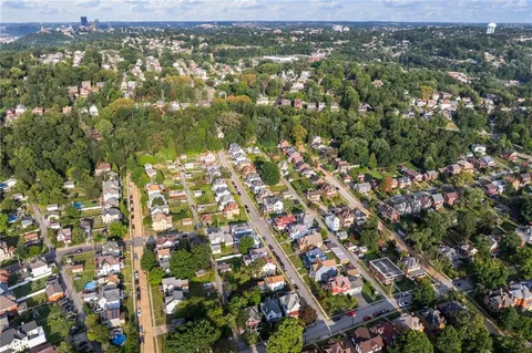 an aerial view of residential houses with city view