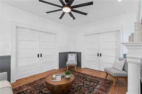 a living room with furniture and wooden floor