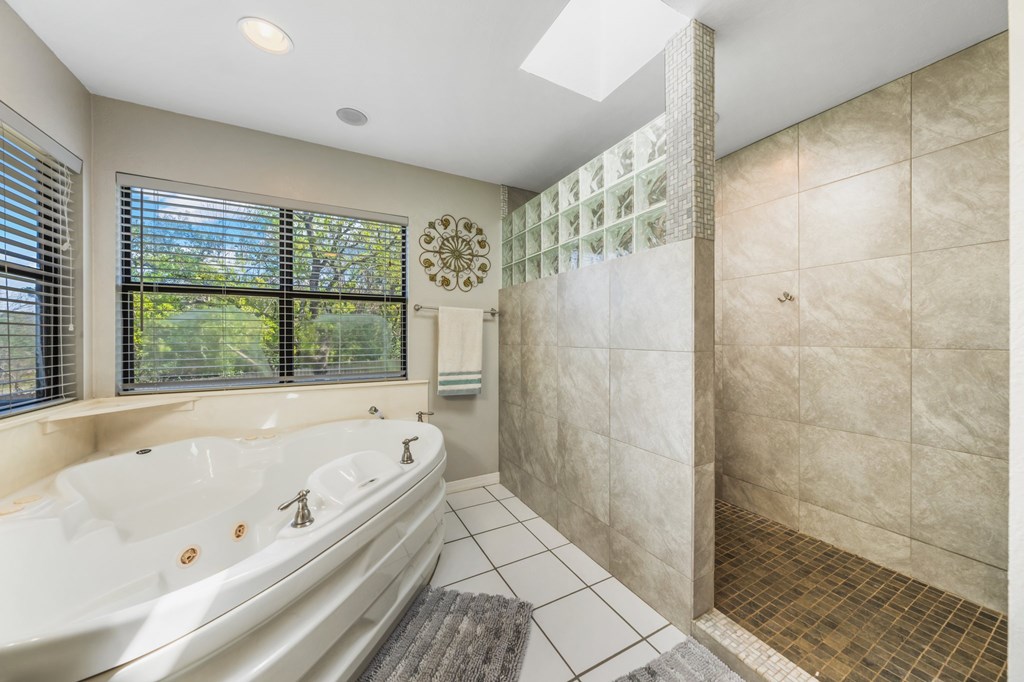 711 Cardinal Drive Kerrville, TX 78028 - Photo 11 of 30 a bathroom with a bathtub and a shower