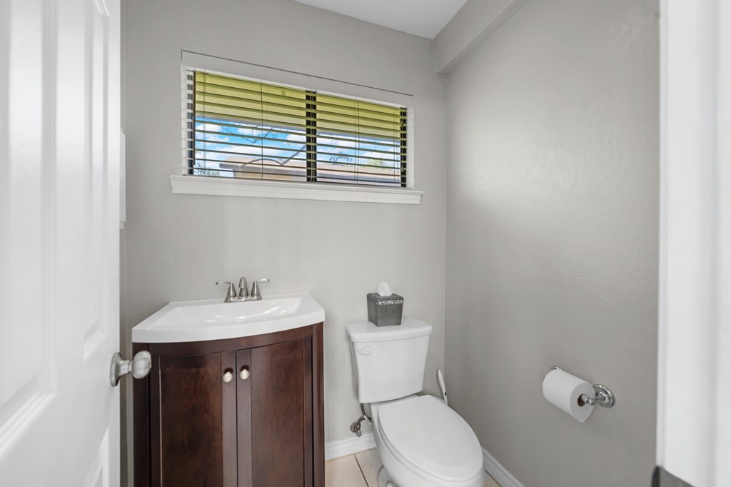 711 Cardinal Drive Kerrville, TX 78028 - Photo 12 of 30 a bathroom with a sink a toilet and a window