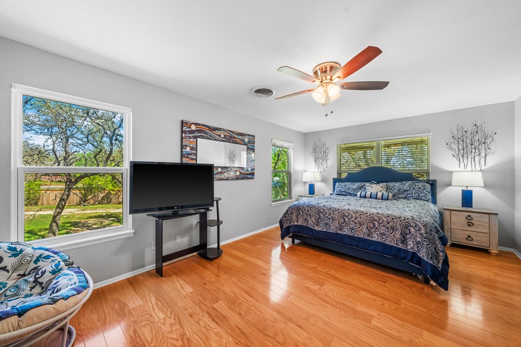 711 Cardinal Drive Kerrville, TX 78028 - Photo 17 of 30 a bedroom with a bed and a flat screen tv
