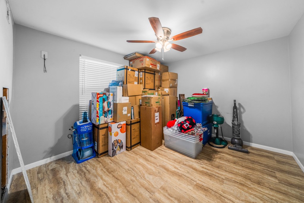 711 Cardinal Drive Kerrville, TX 78028 - Photo 20 of 30 a bedroom with bed and a chandelier