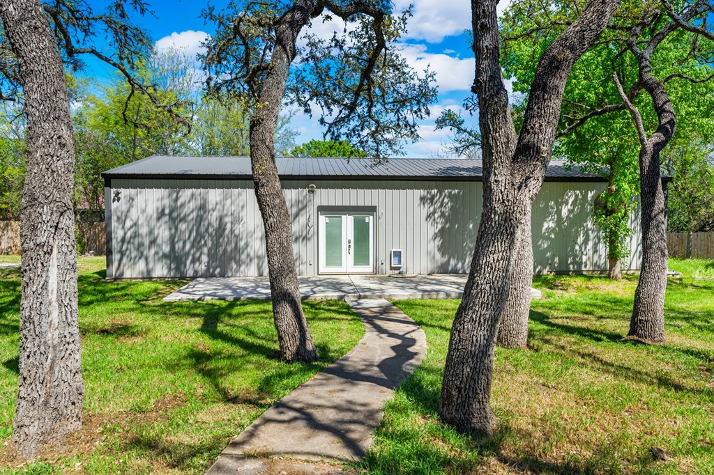 711 Cardinal Drive Kerrville, TX 78028 - Photo 25 of 30 a view of a house with backyard and a tree