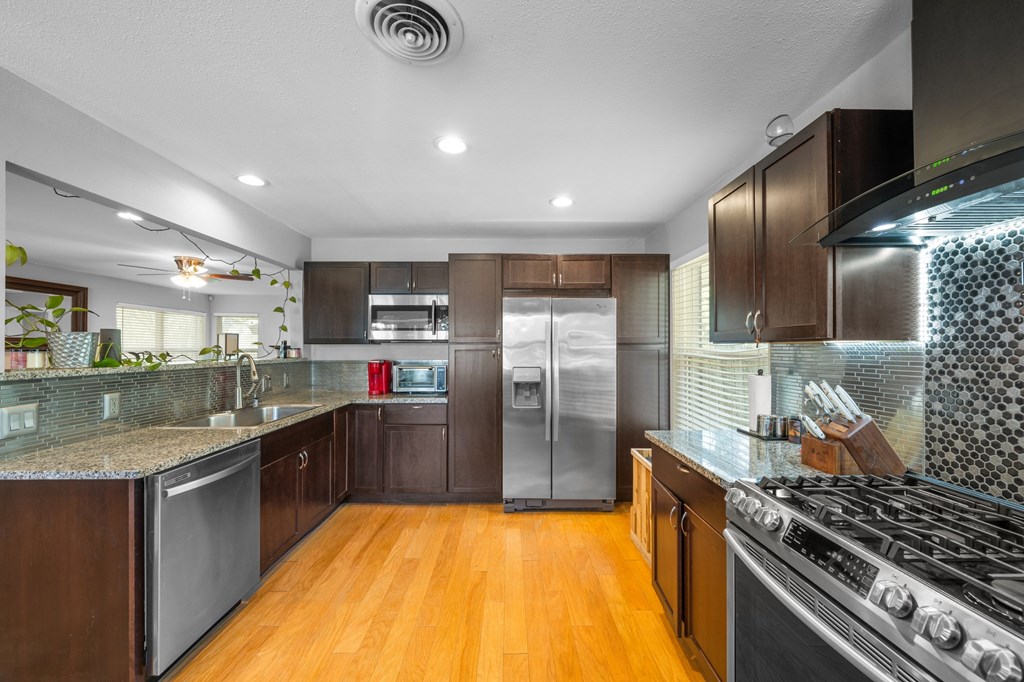 711 Cardinal Drive Kerrville, TX 78028 - Photo 5 of 30 a kitchen with stainless steel appliances granite countertop a stove and a refrigerator