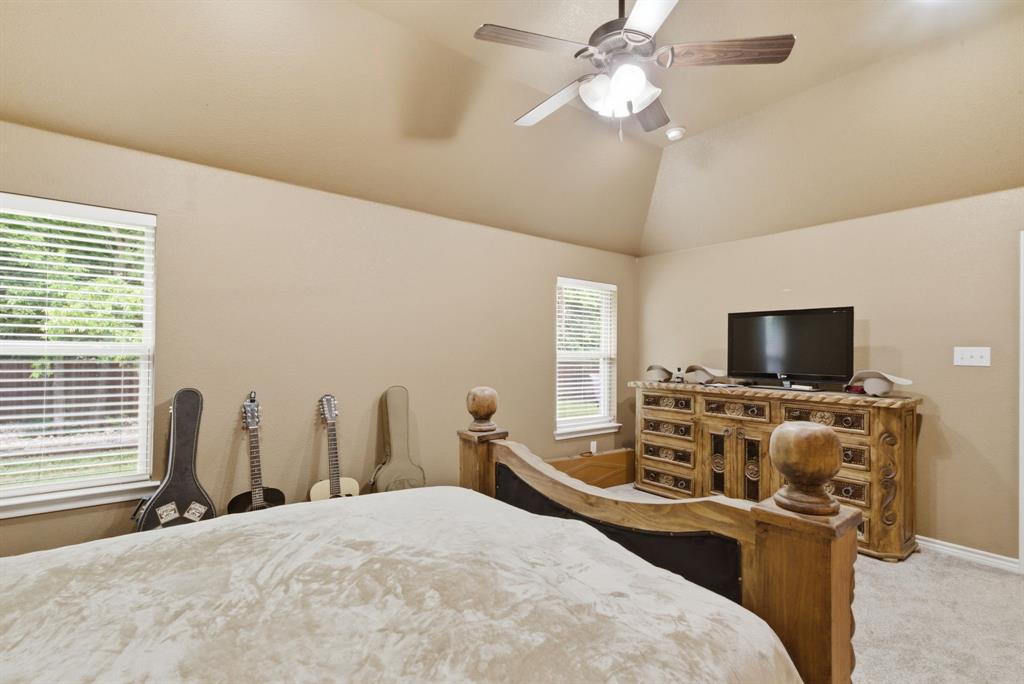 940 Elk Ridge Drive Stephenville, TX 76401 - Photo 13 of 23 a bedroom with a bed and a flat screen tv
