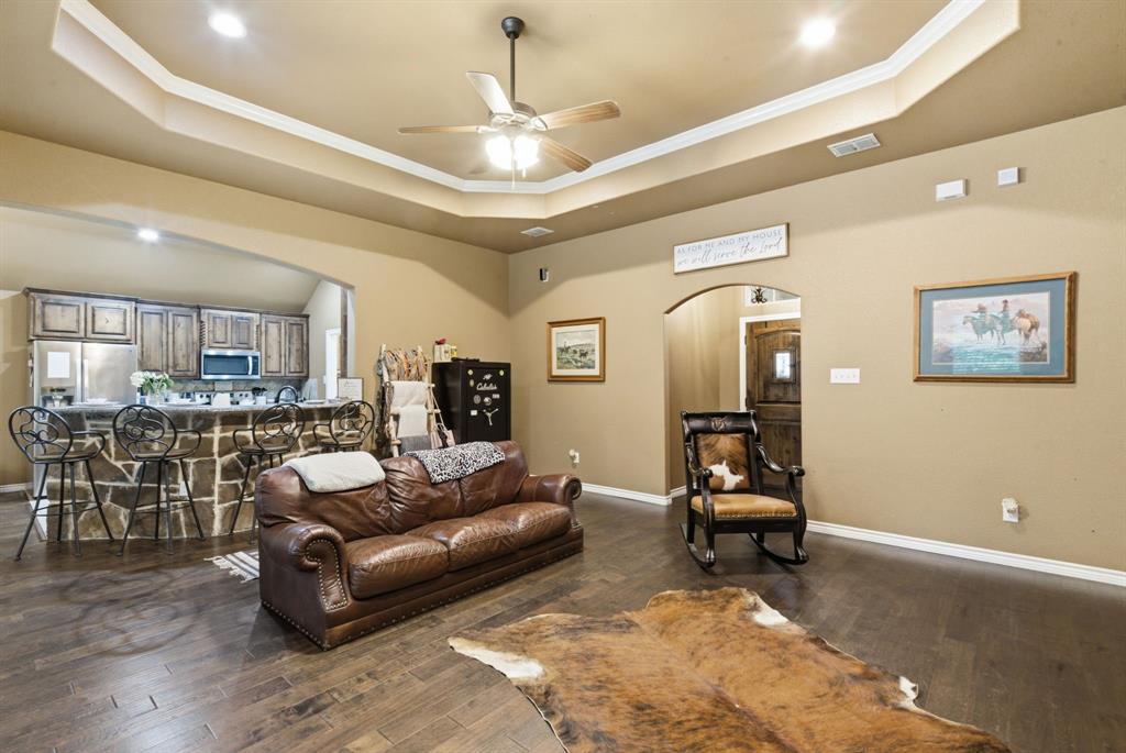 940 Elk Ridge Drive Stephenville, TX 76401 - Photo 2 of 23 a living room with furniture and a chandelier