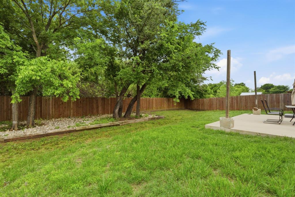 940 Elk Ridge Drive Stephenville, TX 76401 - Photo 22 of 23 a view of a backyard with palm trees