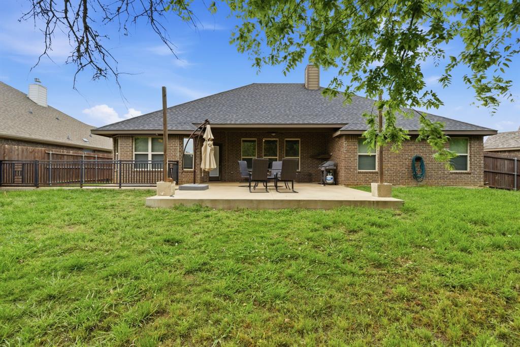 940 Elk Ridge Drive Stephenville, TX 76401 - Photo 23 of 23 a front view of a house with a yard porch and sitting area