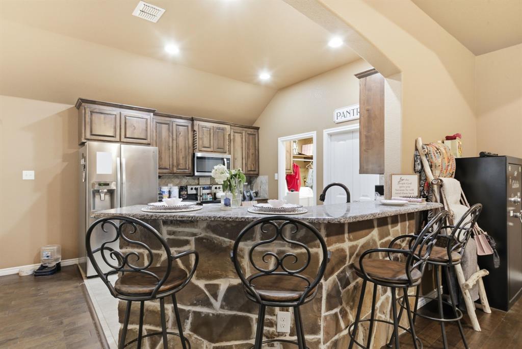 940 Elk Ridge Drive Stephenville, TX 76401 - Photo 6 of 23 a view of a dining room with furniture and wooden floor