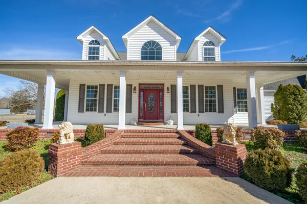 a dining room with wooden floor and furniture