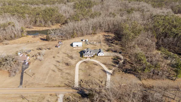 a spacious bathroom with sink double vanity mirror and a bathtub