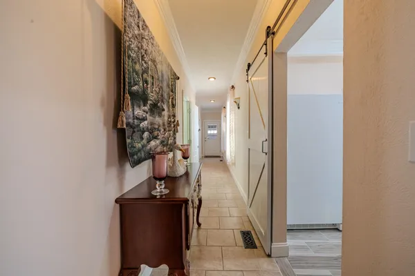 a view of a porch with wooden floor windows and a chandelier