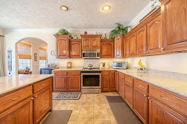 a living room with furniture a fireplace and a table