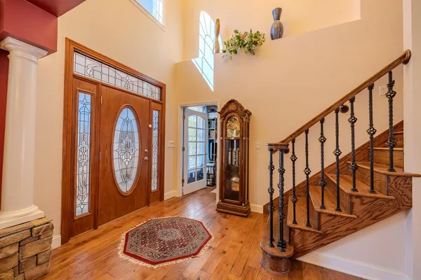 a view of staircase with furniture and frames on wall